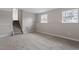 Finished basement with carpet, two double-hung windows, and access to the upper levels at 8341 Wynewood Ct, Raleigh, NC 27616