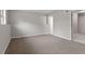 Finished basement with carpet flooring and view to bathroom at 8341 Wynewood Ct, Raleigh, NC 27616