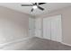 Cozy bedroom with neutral walls, carpet flooring, ceiling fan, and closet for storage at 8341 Wynewood Ct, Raleigh, NC 27616