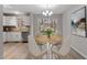 Inviting dining area featuring a round table with four chairs and a modern chandelier at 8341 Wynewood Ct, Raleigh, NC 27616