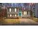 Charming split-level home featuring a quaint front yard, complemented by a vibrant teal-colored front door at 8341 Wynewood Ct, Raleigh, NC 27616