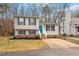 Charming split-level home with manicured lawn, blue door, and black shutters at 8341 Wynewood Ct, Raleigh, NC 27616