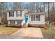 Charming split-level home with manicured lawn, blue door, and black shutters at 8341 Wynewood Ct, Raleigh, NC 27616