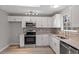 Contemporary kitchen with white cabinetry, stainless steel appliances, and ample counter space at 8341 Wynewood Ct, Raleigh, NC 27616