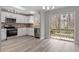 Bright kitchen features stainless appliances, a slider to back deck, and light gray flooring at 8341 Wynewood Ct, Raleigh, NC 27616