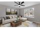 Inviting living room featuring a plush sofa, stylish decor, and natural light from windows at 8341 Wynewood Ct, Raleigh, NC 27616
