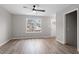 Bright living room with LVP floors, gray walls, and a view of the front yard at 8341 Wynewood Ct, Raleigh, NC 27616
