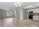 Open-concept with gray walls, modern lighting, and views into the kitchen at 8341 Wynewood Ct, Raleigh, NC 27616