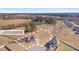 Expansive aerial view of a neighborhood featuring charming homes, wooded areas, and a serene pond at 84 Nonabell Ln, Four Oaks, NC 27524