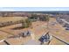Expansive aerial view of a neighborhood featuring charming homes, wooded areas, and a serene pond at 84 Nonabell Ln, Four Oaks, NC 27524