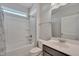 Well-lit bathroom with tub-shower combination, white fixtures and neutral finishes at 84 Nonabell Ln, Four Oaks, NC 27524
