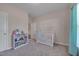 This bedroom features soft carpet, a crib, and a white bookshelf at 84 Nonabell Ln, Four Oaks, NC 27524
