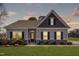Charming single-story home with stone accents, black shutters, and a well-manicured lawn at 84 Nonabell Ln, Four Oaks, NC 27524
