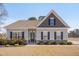 Charming single-story home with gray siding, stone accents, and a well-manicured front yard at 84 Nonabell Ln, Four Oaks, NC 27524