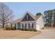 A charming home featuring gray siding, a two-car garage, and a well-kept lawn at 84 Nonabell Ln, Four Oaks, NC 27524