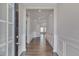Inviting foyer with hardwood floors, wainscoting, and neutral paint at 84 Nonabell Ln, Four Oaks, NC 27524