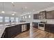 Stylish kitchen with an island, stainless steel appliances, and dark wood cabinets at 84 Nonabell Ln, Four Oaks, NC 27524