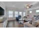 Spacious living room features ample seating, wood floors, natural light, and a ceiling fan at 84 Nonabell Ln, Four Oaks, NC 27524