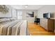 Serene bedroom featuring hardwood floors, neutral walls, and a comfortable bed at 912 Homestead Park Dr, Apex, NC 27502