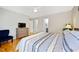 Comfortable bedroom featuring wood floors, neutral walls, and access to the en-suite bathroom at 912 Homestead Park Dr, Apex, NC 27502