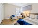 Comfortable bedroom has twin beds, neutral walls, luxury vinyl plank flooring, and a window at 912 Homestead Park Dr, Apex, NC 27502