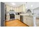 Well-lit kitchen with stainless steel appliances, white cabinets, and granite countertops at 912 Homestead Park Dr, Apex, NC 27502