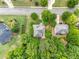 An aerial view of a property with mature trees, manicured lawns, and lush landscaping at 94 Fawn Hill Ct, Garner, NC 27529