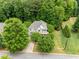Aerial view of a beautiful home nestled among mature trees, providing privacy and charm at 94 Fawn Hill Ct, Garner, NC 27529