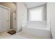 Bathroom showcasing soaking tub, shower, and tile flooring at 94 Fawn Hill Ct, Garner, NC 27529