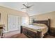 Spacious bedroom with neutral carpet, ceiling fan and large bed, creating a peaceful retreat at 94 Fawn Hill Ct, Garner, NC 27529