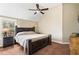 Cozy bedroom with a dark wood bed frame, neutral carpet, and a ceiling fan for comfort at 94 Fawn Hill Ct, Garner, NC 27529