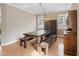 Cozy dining room featuring a rustic wooden table, bench seating, and a stylish display cabinet at 94 Fawn Hill Ct, Garner, NC 27529