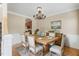 Charming dining room boasts a rustic wooden table, seating for six, and stylish chandelier at 94 Fawn Hill Ct, Garner, NC 27529