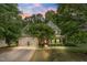 Charming two-story home with a manicured lawn, mature trees, and a welcoming front porch at 94 Fawn Hill Ct, Garner, NC 27529