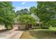Charming two-story home with a manicured lawn, mature trees, and a welcoming front porch at 94 Fawn Hill Ct, Garner, NC 27529