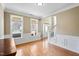 Bright living room with large windows, wainscoting, and access to the foyer at 94 Fawn Hill Ct, Garner, NC 27529