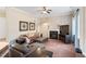 Comfortable living room with a fireplace, ceiling fan, and plush seating, perfect for relaxation at 94 Fawn Hill Ct, Garner, NC 27529