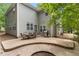 Back patio with a stone fire pit, grill and outdoor dining set, perfect for entertaining at 94 Fawn Hill Ct, Garner, NC 27529