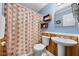 Cozy bathroom with blue walls, a pedestal sink, and a patterned shower curtain at 1008 Torredge Rd, Durham, NC 27712