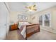 Comfortable bedroom with a ceiling fan, a window and a queen-sized bed at 1008 Torredge Rd, Durham, NC 27712