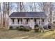 A beautifully designed front exterior featuring a delightful porch and manicured shrubs that enhance curb appeal at 1008 Torredge Rd, Durham, NC 27712