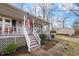 Inviting front porch with classic railings and steps, complemented by neat landscaping for an appealing entrance at 1008 Torredge Rd, Durham, NC 27712