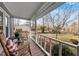Relax on the charming front porch with rocking chairs, offering a perfect spot to enjoy the serene surroundings at 1008 Torredge Rd, Durham, NC 27712