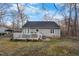 Back of house featuring a spacious deck and landscaped yard, ideal for outdoor gatherings and relaxation at 1008 Torredge Rd, Durham, NC 27712