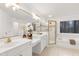 A primary bathroom features a double sink vanity, a tub, and a glass enclosed shower at 102 Legault Dr, Cary, NC 27513