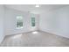 A bright bedroom features two large windows with views and a neutral color palette at 102 Legault Dr, Cary, NC 27513