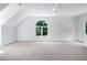 Large bonus room boasts natural light from a picture window and a neutral color palette at 102 Legault Dr, Cary, NC 27513