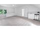 A spacious bonus room features a beverage bar, neutral decor, and a ceiling fan at 102 Legault Dr, Cary, NC 27513