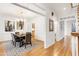Open-concept dining room featuring hardwood floors, neutral walls, and a modern chandelier at 102 Legault Dr, Cary, NC 27513