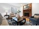 Cozy living room with a brick fireplace, hardwood floors, and neutral-toned furniture at 102 Legault Dr, Cary, NC 27513